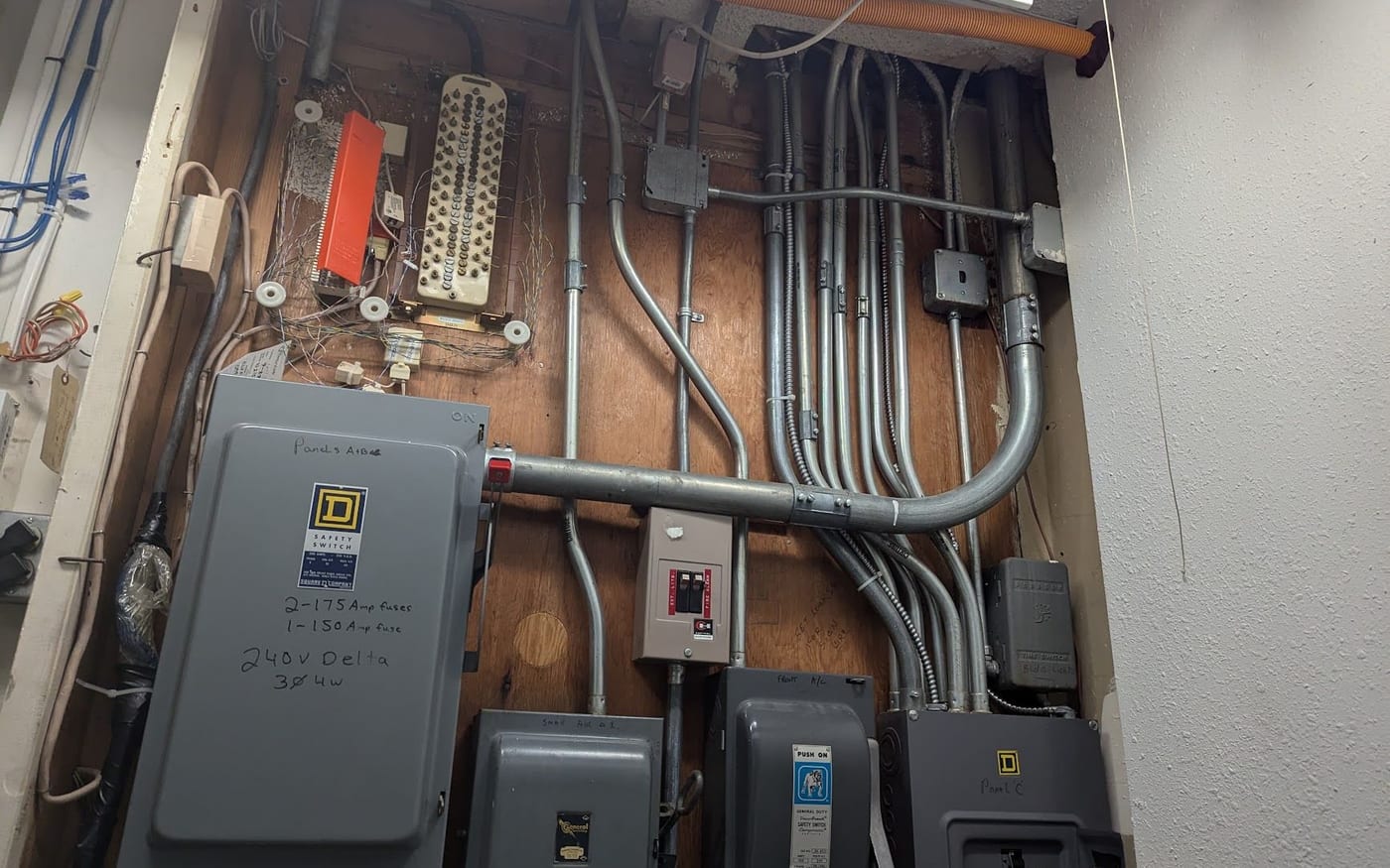 Commercial electrical room with conduit runs, safety switches and distribution panels