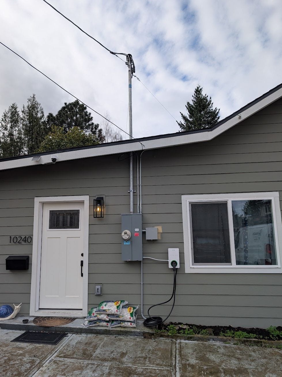 EV charger installed on an exterior wall beside the electrical meter