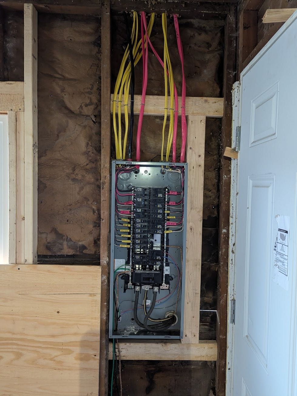 Electrical panel with the dead front removed and new circuits landed