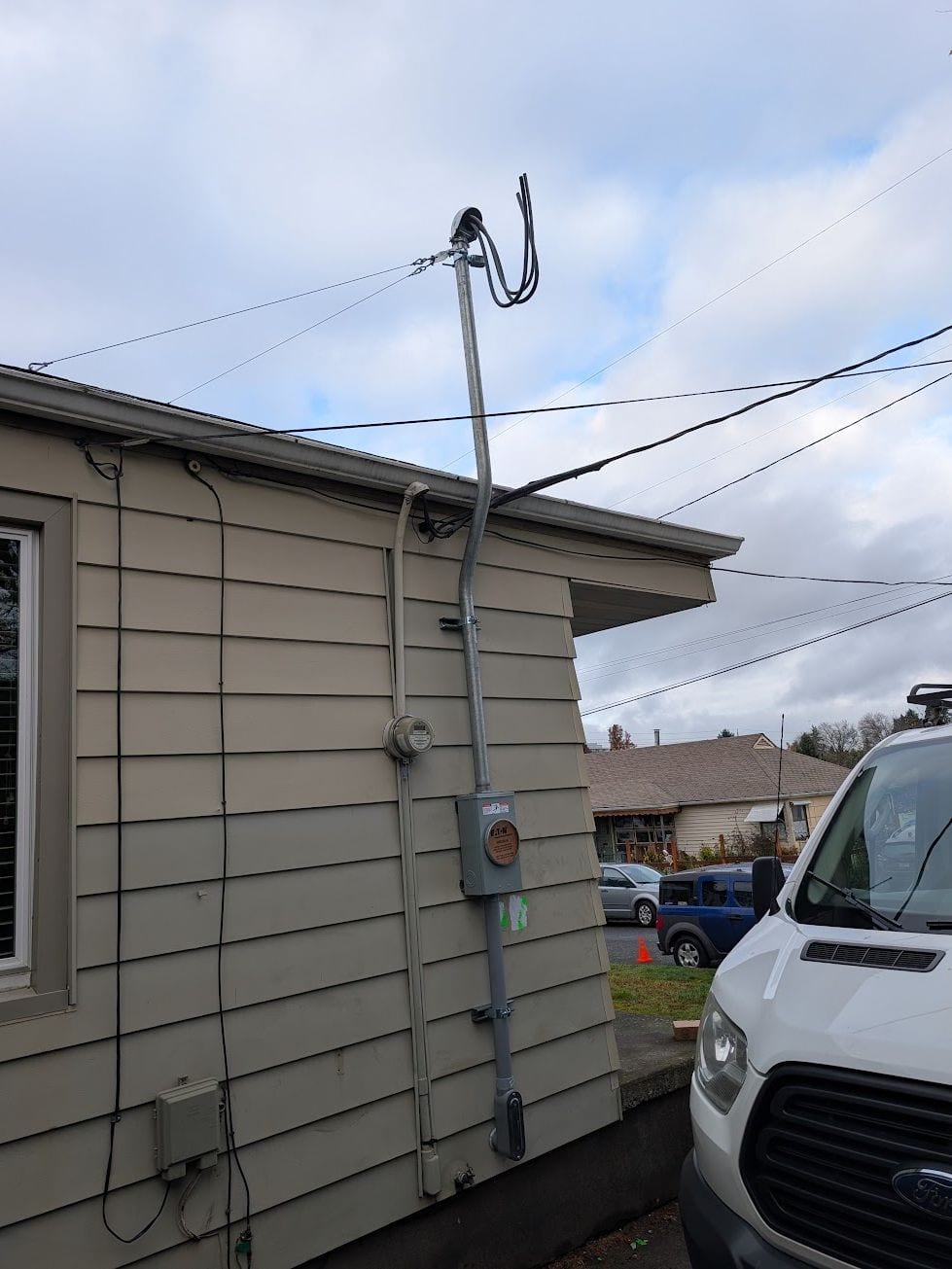 Exterior electrical service mast, meter base and disconnect on a home
