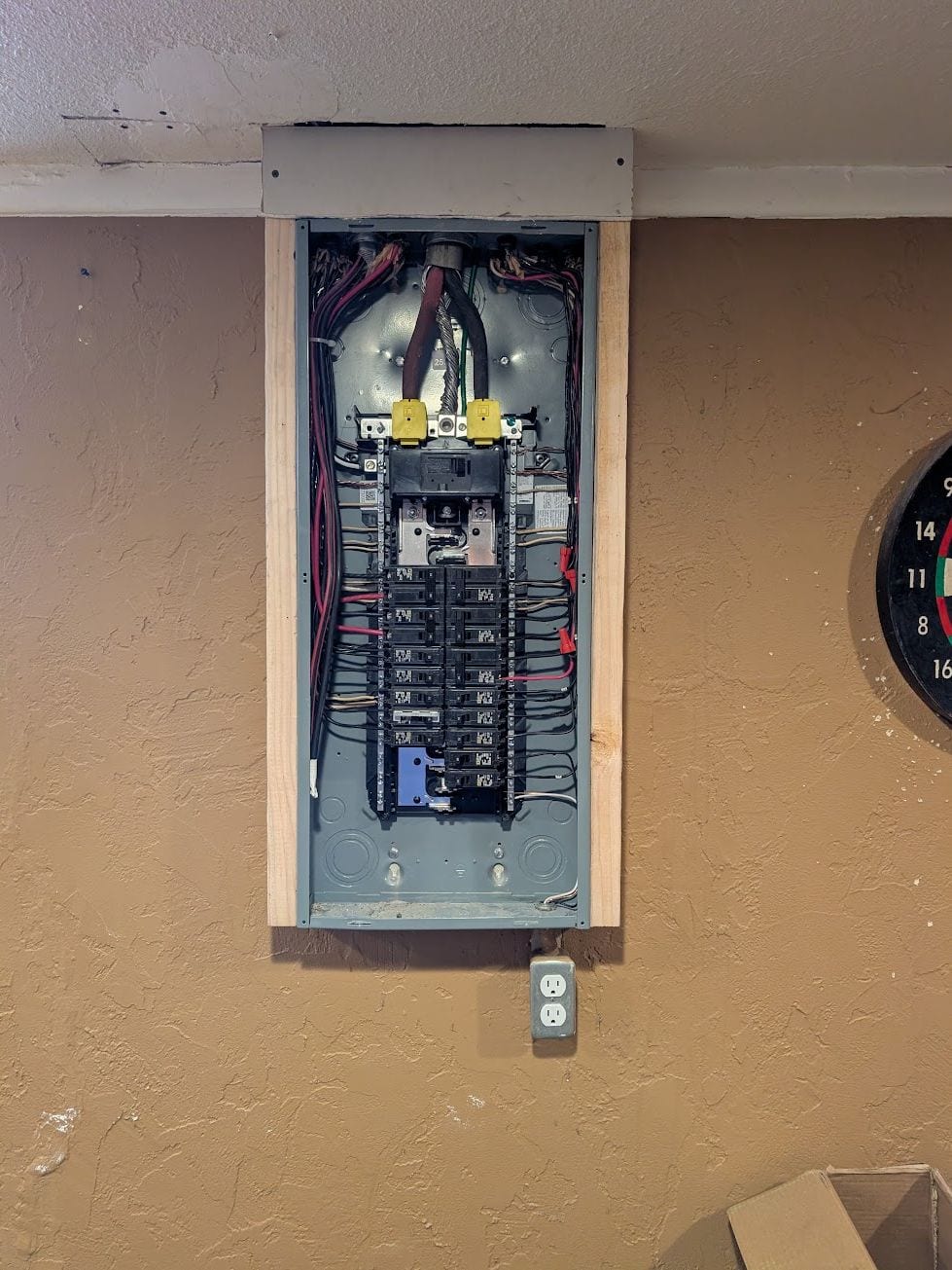 Electrical panel opened in the wall of a finished home