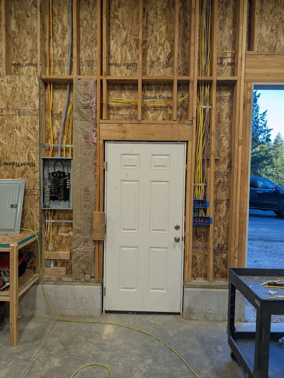 New circuits run through open wall framing during a rewire