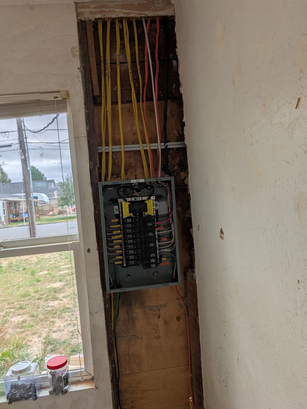 Wall opened above a panel to run new cable