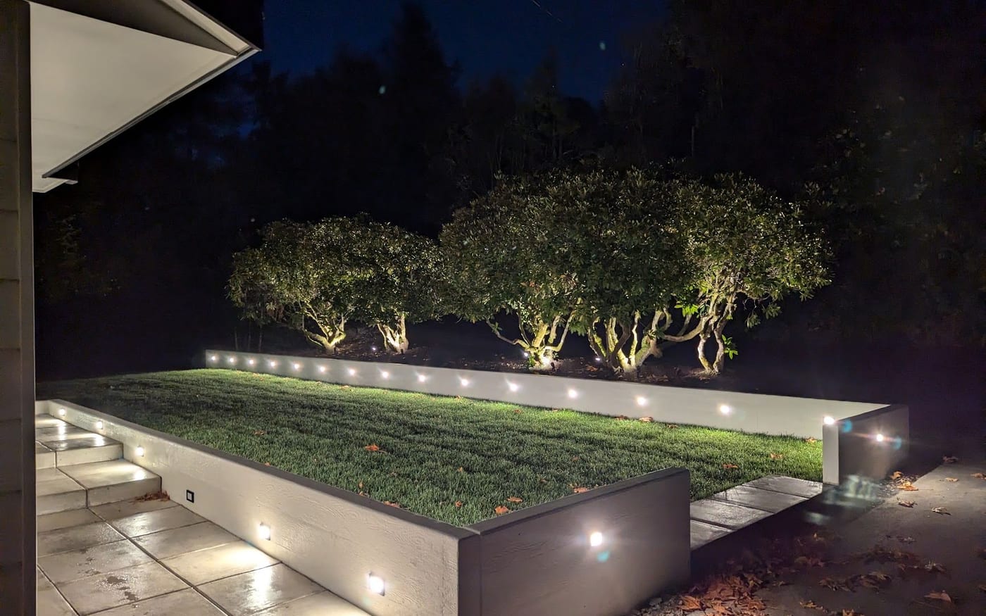 Exterior wall lighting along a retaining wall after dark
